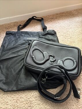 Vlieger & Vandam black grain leather camera bag with raised handcuff detail.